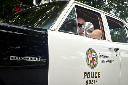 Off-duty police officer Mike Dewey in a 1969 Plymouth Belvedere, a replica of the police cruiser in the TV show "Adam-12," along Generals Highway in Annapolis. A career police officer in the greater Annapolis area and fan of the show, Dewey purchased the restored car as a recreational vehicle to drive around on weekends.
