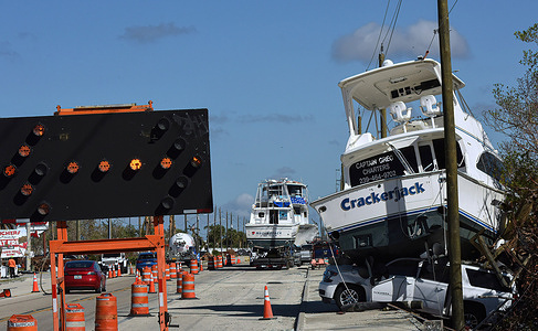 Boats blown from a nearby marina are seen along the side of a road in Fort Myers Beach, Florida over a month after Hurricane Ian made landfall as a Category 4 hurricane. The storm caused an estimated $67 billion in insured losses and at least 127 storm-related deaths in Florida.