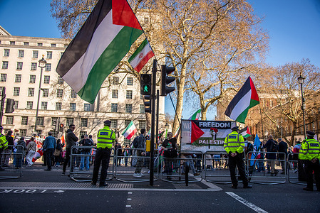 Police officers stand on guard during the Stop Bombing Iran – Hands Off Lebanon – Free Palestine March in London.