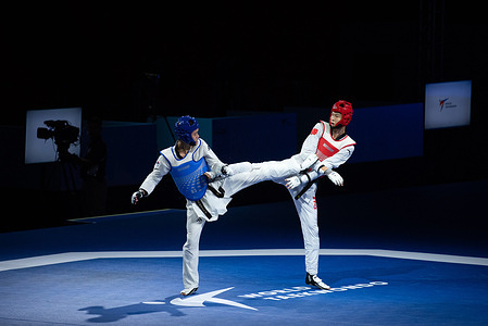 Kim Jongmyeong from South Korea (Blue) and Huang Kefen from China (Red) seen in action during the 58kg. men World Taekwondo Grand Prix Challenge 2025 at the Indoor stadium Huamark.
