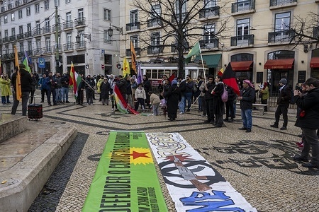 Activists hold flags during a rally. The Portuguese capital hosted a new day of social mobilization in solidarity with the Kurdish people and the Rojava region, joining a wave of protests sweeping across major European capitals. Organized by Portuguese social platforms such as the Plataforma de Solidariedade com os Povos do Curdistão (Platform for Solidarity with the Peoples of Kurdistan) and civil society groups, the rally and subsequent march aimed to denounce the recent escalation of violence and military attacks by Syrian forces against Kurdish communities in the north of the country.