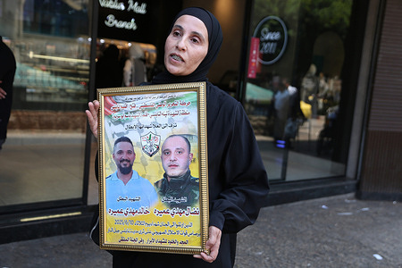 Palestinian woman Manal Amara, holds a poster of her husband Nidal Amara and her brother Khaled Amara, demanding the release of their bodies which are being held by Israeli forces. Nidal Amara and Khaled Amara were killed a year ago by Israeli forces in Nablus's Old City. The Israeli army continues to hold hundreds of Palestinian bodies.
