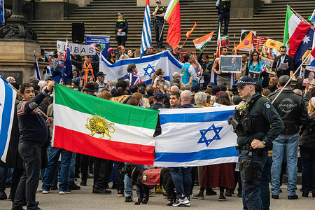 Protestors hold up Israeli and pre-revolutionary Iranian flags in a show of solidarity against terrorism and authoritarian regimes during a national rally on the steps of the Victorian Parliament. Members of Melbourne’s Iranian, Hindu, and Jewish communities gathered on the steps of Parliament House on Sunday, 6 July 2025, for a peaceful rally condemning terrorism and authoritarian regimes. Organised in response to escalating global tensions—including a deadly attack in Pahalgam, India—the demonstration expressed solidarity with victims of the Iranian regime, Israeli civilians, and others impacted by extremist violence.