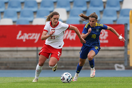 Paulina Tomasiak of Poland (L) and Viktoriia Holovach of Ukraine (R) seen in action during the friendly match between Poland and Ukraine at Municipal Stadium. Final score; Poland 4:0 Ukraine