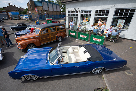 A Blue 1969 Lincoln Continental Mark III parked at the Krispy Kreme classic car meet at Shannon Corner. Classic car owners and motoring enthusiasts gathered at the monthly Shannon Corner Classic Car Meet outside the Krispy Kreme drive-thru in New Malden, London. Held on the third Sunday of every month, the informal event attracts owners of classic, vintage, American, custom and performance vehicles from across London, Surrey and the surrounding areas.