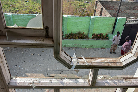 Kashmir residents inspect damage to a building near the site of an explosion at a police station in Srinagar. Nine persons were killed and dozens were injured in a major explosion inside a Police Station. Explosives reportedly detonated during a forensic investigation as part of a probe into an earlier blast in India’s capital, New Delhi, that killed 13 people and injured dozens.