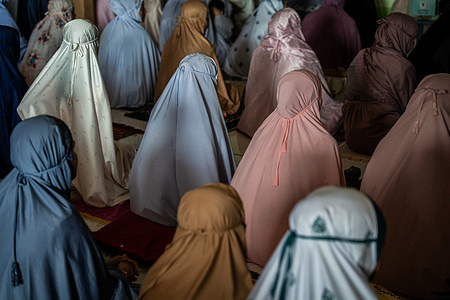 Muslim women perform Eid al-Fitr prayers during a morning session inside a mosque as Ramadan comes to an end. Muslim women attend morning prayers at a mosque in Narathiwat as Thailand marks Eid al-Fitr, the end of Ramadan.