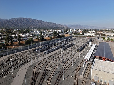 (EDITORS NOTE: Image taken with drone) An aerial view of the LA Metro Division 24 light rail maintenance facility in Monrovia, California, on June 3, 2026. Metro light rail vehicles are parked on multiple storage tracks alongside maintenance infrastructure at the operations and maintenance complex, which serves as a key hub for rail transit operations in the Los Angeles region.