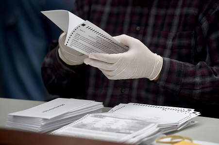 County employee opens mail-in ballots at the Luzerne County Bureau of Elections.
As the polling stations in Pennsylvania state close, the ballots for the 2020 presidential election are being transported to the vote counting centers managed by the Board of Elections for counting, media are allowed to document the vote counting process in Pennsylvania.