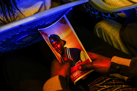 A mourner holds an eulogy bearing the picture of 19-year-old Anthony Kariuki, during the burial ceremony. Anthony Kariuki, 19-years old, who was killed by police during the Saba Saba demonstrations in Naivasha, has been laid to rest in Subukia, Nakuru County, in a burial ceremony marked by strong condemnation of police brutality. According to a human rights report, at least 60 lives have been lost to police shootings during two demonstrations held in June and July.