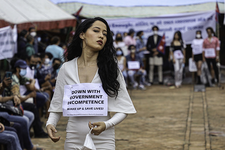 A model with a placard cat walking during the protest.
Models catwalk in solidarity with the youths who are on a hunger strike calling for concerned ministers to address the agreement promised by the government for a better COVID 19 response and corruption at Basantapur Durbar Square.