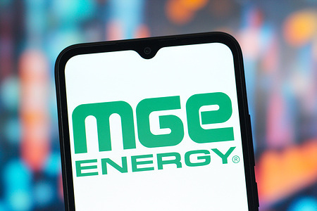 In this photo illustration, the MGE Energy logo is seen displayed on a smartphone screen.