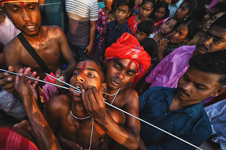 (EDITORS NOTE: Image contains graphic content) 
A Hindu devotee is pierced with sharp needles during the Gajan observation. Gajan Festival is one of the oldest Folk festivals where devotees show their faith by self inflicting pain on themselves, in the belief that Lord Shiva will help them overcome troubles in their daily lives.