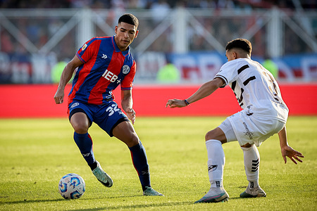 Ezequiel Herrera of San Lorenzo (L) and Tomas Silva of Platense (R) seen in action during the match between San Lorenzo vs Platense as part of semifinals of the Argentine professional soccer league at Predro Bidegain Stadium. (Final score: San Lorenzo 0 - 1 Platense)