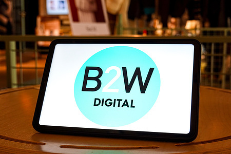 In this photo illustration, the logo of B2W Digital is seen displayed on the screen of a tablet.