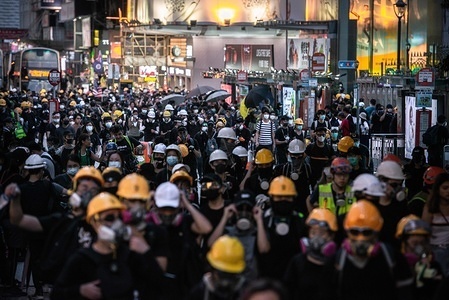 Protesters preparing to march to the police headquarters in Tsim Sha Tsui during the demonstrations.
Police agents and protesters clash in Nathan Road, Tsim Sha Tsui. A total of 35 people were arrested when Protesters took to the street to demonstrate against the government, they demand the complete withdraw of the extradition bill, and for the government to set up an independent inquiry into the recent clashes between protester and police. Police fired tear gas in response to another weekend of protests.