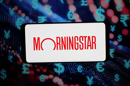 In this photo illustration, the logo of US financial company Morningstar Inc. is seen displayed on a smartphone in front of an abstract background on a computer screen.