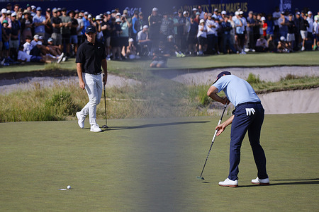 Adam Scott of Australia (R) and Northern Ireland's Rory McIlroy (L) seen in action during round two of the Australian Open Golf tournament.  The second round of the men’s Australian Open takes place at Royal Melbourne Golf Club with top Australian and international players in action for one of the country’s most prestigious golf titles.