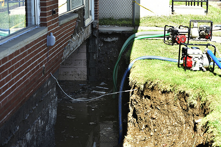 The fire department tries to pump water from a collapsed basement after flood waters took down the wall and yard. 
Remnants from Hurricane Ida that caused a death toll of 14, flooding, road closures, property damage. One home lost its foundation and will be a total loss. As the storm went into NY it caused much more flooding.