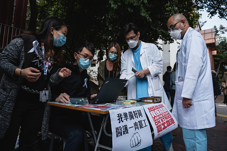 Doctors register for the medical workers strike in support of the Hong Kong-mainland border closure.
Hundreds of medical workers participated in a strike in support of the complete closure of the Hong Kong - Mainland China border. The strike is potential a weeklong event if the government fails to address the Workers' Union concerns over the spread of the 2019 Coronavirus from mainland China into Hong Kong. Medical workers registered their participation in the strike with the union and raised various placards.