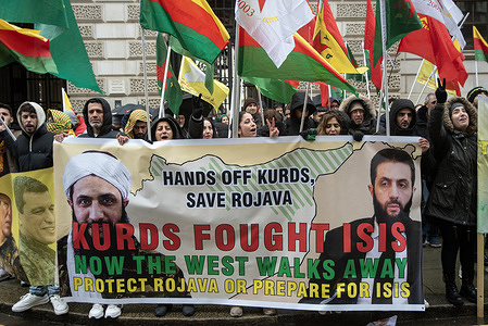 Kurdish protesters hold a banner with the photos of the Syrian President, Ahmed al-Sharaa on it during the demonstration outside the Foreign, Commonwealth & Development Office. Around a hundred protesters from the Kurdish diaspora gathered outside the Foreign, Commonwealth & Development Office, calling on the UK government to take action against the Syrian military's offensive on Kurdish held area in northeast Syria (Rojava).