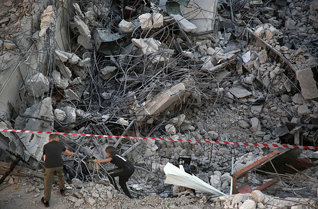 Palestinians inspect a blacksmith workshop after it was demolished by Israeli military bulldozers in the eastern West Bank. The Israeli occupational forces destroyed a blacksmith workshop claiming that it was used to manufacture combat equipment.