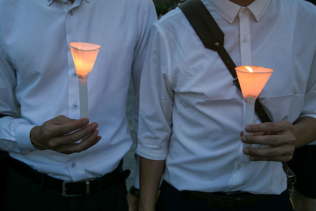 Two young men are seen holding lit candles during Tiananmen Anniversary.Thousands of Hong Kong People defy the public gathering ban imposed by government following the Coronavirus (COVID-19) crisis situation and gather at Victoria Park for Tiananmen Anniversary.