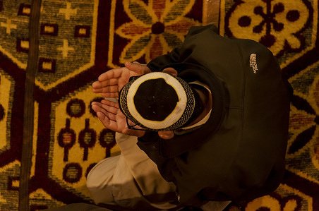 A Kashmiri Muslim man raises his hands as he prays inside a shrine on the ninth day of Islamic month of Ramadan in Srinagar.