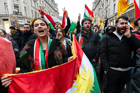Protesters seen marching. Kurdish demonstrators gathered outside the BBC headquarters to protest against what they described as ongoing aggression by the Syrian government against Kurdish regions, calling on the broadcaster to increase coverage of the situation in Kurdistan. Protesters held flags and placards while chanting slogans demanding international attention and accountability for alleged human rights abuses.