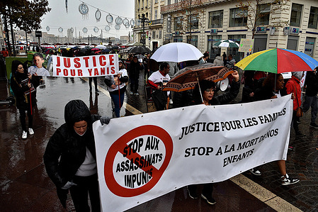 Protesters hold banners during the demonstration. People demonstrate in memory of Yanis, an 8-year-old boy who was run over by a female driver near Perpignan on February 5, 2022.