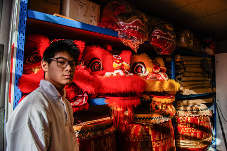 A man walks past the lion heads during the celebration. The Chinese-Asian district (Chinatown) of The Hague celebrated the Chinese New Year with lion and dragon dancers, parading through the district to ensure that evil spirits were chased away and bring prosperity and happiness for the new year, the year of the Snake.
