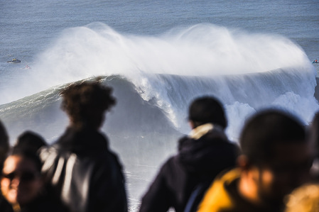 An empty wave breaks in front of the of spectators watching from the cliff during the Tudor Nazare Big Wave Challenge at Praia do Norte.