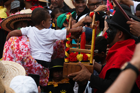 A child touches the image of San Pedro during the festival. La Parranda de San Pedro is a festivity in honor of the apostle San Pedro in the town of Guatire, Miranda state in Venezuela. This tradition is more than 200 years old and every June 29 is celebrated, it was declared by UNESCO as Intangible Cultural Heritage of Humanity in 2013.