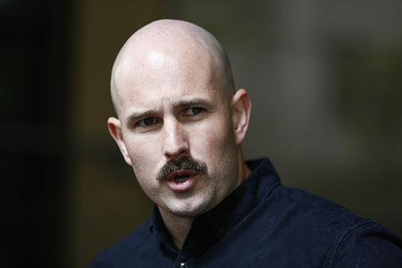 Thomas Sewell, leader of the National Socialist Network, speaks to the press outside the Melbourne Magistrates Court. Thomas Sewell, a far-right figure, is facing charges including violent disorder and assault over an alleged attack at Camp Sovereignty in Melbourne. He remains on bail as the case continues in court.