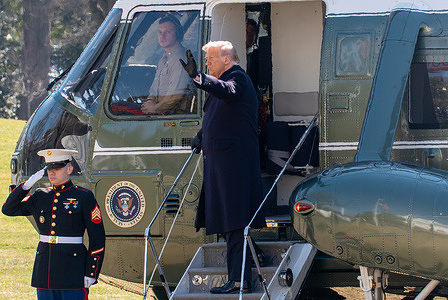 President Trump waves as he boards Marine One from the South Lawn of the White House, in Washington.