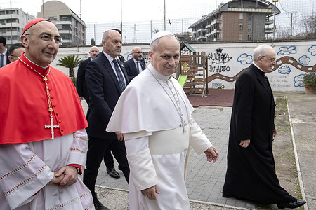 Pope Leo XIV arrives, accompanied by Cardinal Baldassare Reina (L) and Monsignor Leonardo Sapienza (R), for the visit to the parish of the Ascension of Our Lord Jesus Christ in Quarticciolo, a neighborhood in the eastern outskirts of Rome.