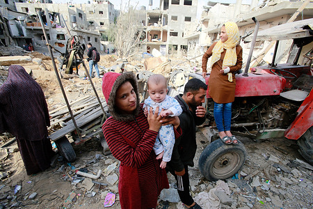 Palestinian family who have returned to their neighborhood, stare at the damages from their home, hit by Israeli bombardment in Gaza City.
A ceasefire between Israel and Hamas, the Islamist movement which controls the Gaza strip, appeared to hold today after 11 days of deadly fighting that pounded the Palestinian enclave and forced countless Israelis to seek shelter from rockets.