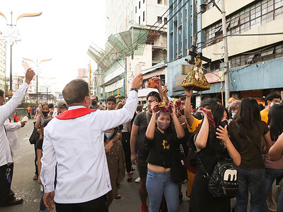 Quiapo Church Lay Ministers bless the devotees with holy water. Catholic devotees flock to Quiapo Church in Manila to express their devotion to the Black Nazarene, a life-sized image of dark skinned, kneeling Jesus Christ carrying the cross. A day before it's feast on January 9. This festive activity was put on hold for two years because of the COVID-19 pandemic.
