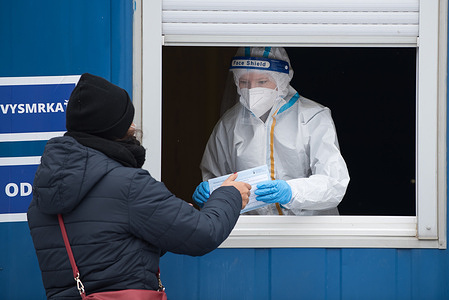 A health worker wearing a protective suit gives out results of coronavirus test to a woman at the testing facility.
As the Covid-19 situation in Slovakia remains critical, Slovak government with PM Igor Matovic have introduced mass testing of the population. Starting today 18th of January large-scale testing will continue until 26th of January. The government hopes the nationwide testing will speed up a recovery from the latest wave of the coronavirus.