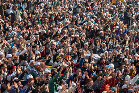 Muslim devotees offer prayers as a priest displays a relic marking the urs, or death anniversary of the Sufi saint at the shrine of Sheikh Abdul Qadir Jeelani famously known as Dastgeer Sahib (RA) in Khanyar, Srinagar.