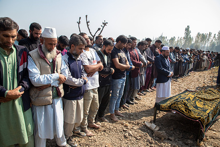 Relatives and neighbors offer funeral prayers near the coffin of a Kashmiri doctor Shahnawaz Ahmed Dar at his native village Naidgam area in Budgam district, south-west of Srinagar. Shahnawaz was killed after suspected militants opened fire on the camp that housed labourers of a private firm working on the construction of a tunnel in the Kashmir's Ganderbal district. Seven people were shot dead, and five others were injured in a suspected militant attack in Jammu and Kashmir's Ganderbal on Sunday. According to officials, while two labourers died on the spot, three others and a doctor later succumbed to their injuries.
