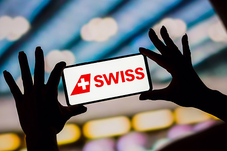 In this photo illustration, the Swiss International Air Lines logo is displayed on a smartphone screen.
