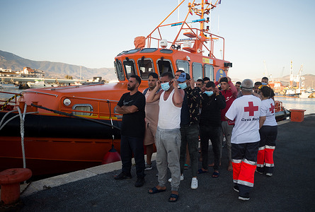Migrants are seen waiting in a queue outside a rescue boat on arrival at the port of Motril.
A total of 35 migrants (of them, 15 algerians and 20 moroccan) were rescued from two dinghies trying to cross the Alboran Sea and brought to Motril harbor, where they were assisted by the Spanish Red Cross.