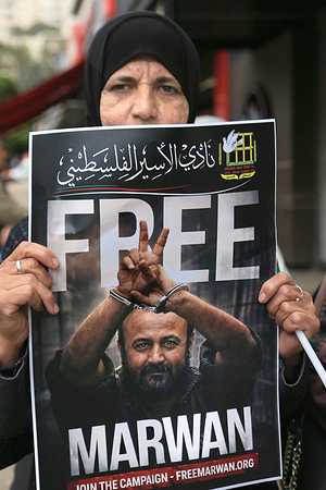 A Palestinian woman holds a poster of Marwan Barghouti, a Fatah leader from the movement headed by President Mahmoud Abbas, who is imprisoned in Israeli jail, during a sit-in protest in Nablus, West Bank. Released Palestinian prisoners reported that they suffered from malnutrition, and some lived in harsh conditions inside Israeli detention centers.