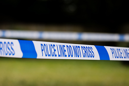 Police tape seen at a crime scene.