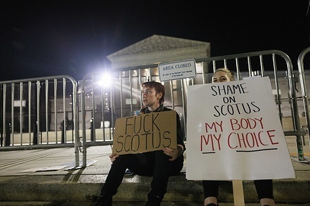(EDITORS NOTE: Image contains profanity) 
Two protesters hold placards outside the Supreme Court of the United States after a conservative majority struck down Roe v Wade. The Court's decision in Dobbs v Jackson Women's Health overturns the landmark 50-year-old Roe v Wade case and erases a federal right to an abortion.