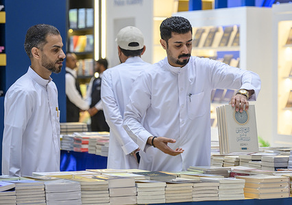 An exhibitor arranges books following the opening of the 35th edition of the Doha International Book Fair at the Doha Exhibition and Convention Center. The Doha International Book Fair takes place from May 14 to 23.