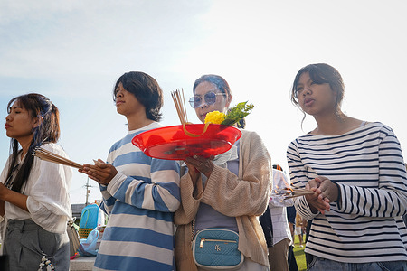 People pray to celebrate the arrival of the New Year at a city shrine.