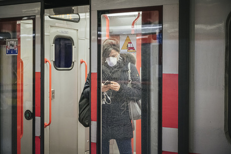 A woman inside a tram wears a protective mask amid Coronavirus fears.
Despite the modification of the regional decree ordering the closure of bars, pubs at 18.00, tourists demand quickly dropped down for concerns on travel safety in Italy during the COVID-19 emergency. The Financial sector has also been affected by the emergency, with a relevant drop in Piazza Affari, tourist operators and workers from restaurants, cultural activities and entertainment sectors demanded a quick return to normality or other solutions for saving their business.