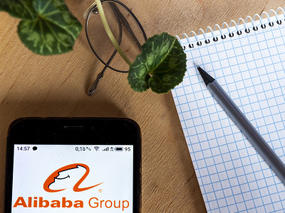 In this photo illustration an Alibaba Group logo seen displayed on a smartphone.